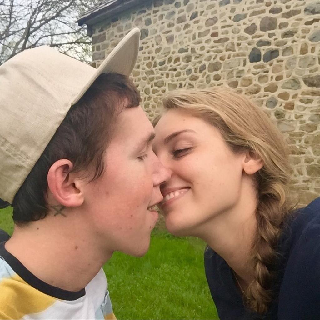 Shane Burcaw and Hannah Aylward kissing.
