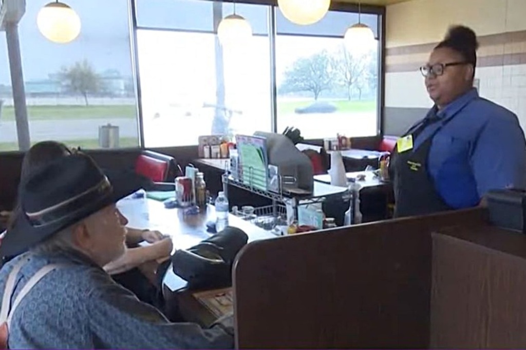 Waitress helps elderly customer