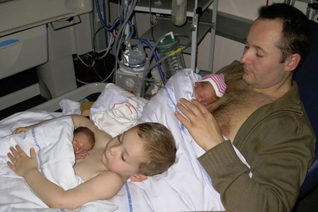 brother helping dad baby